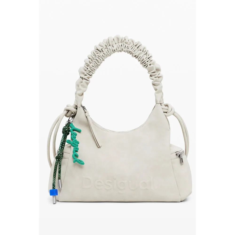 Beige Desigual women's polyurethane handbag with ruched top handle, embossed logo, side zip pocket, and green charm.