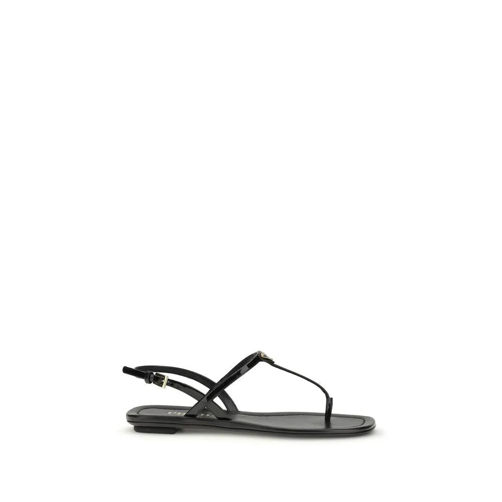 Black patent leather Prada flip-flop sandals with metal triangle logo and adjustable ankle strap.