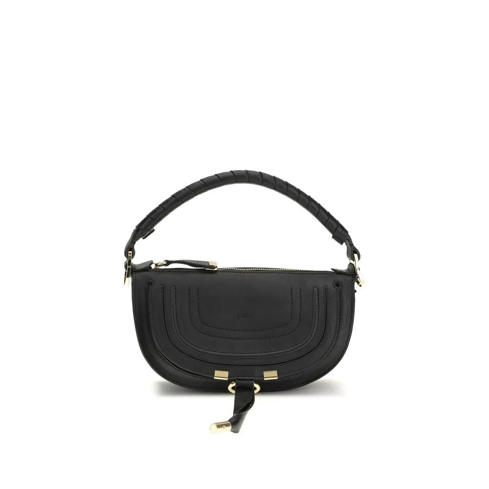 Black Chloé Marcie mini saddle bag in smooth calfskin, with a wrapped handle, gold hardware, and leather tassel.
