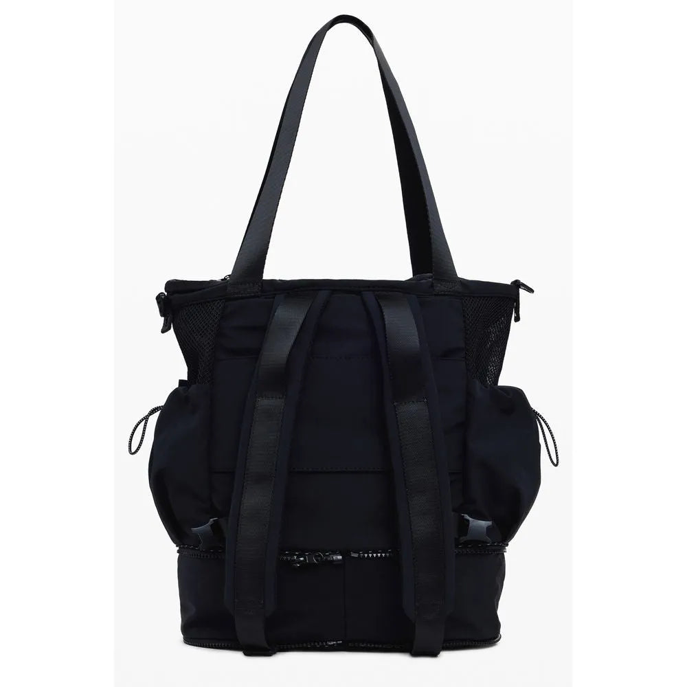 Black polyester DESIGUAL convertible bag, shown as a backpack with adjustable straps, mesh pockets, and multiple compartments.