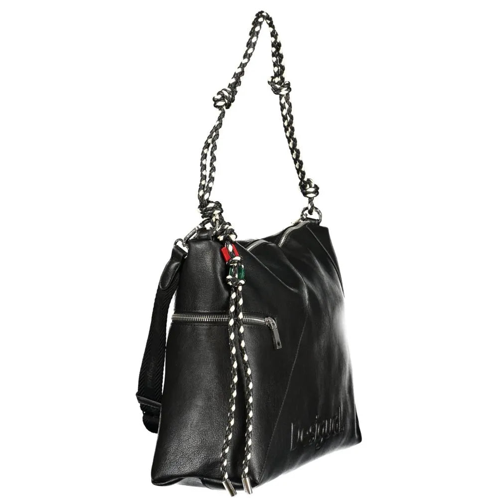 Black Desigual women's polyurethane handbag with braided chain strap, front zip pocket, embossed logo, and colorful charm.