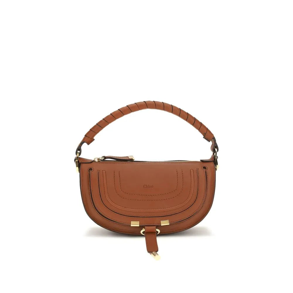 Smooth brown calf leather mini saddle bag with a hand-wrapped top handle, gold hardware, and leather tassel.