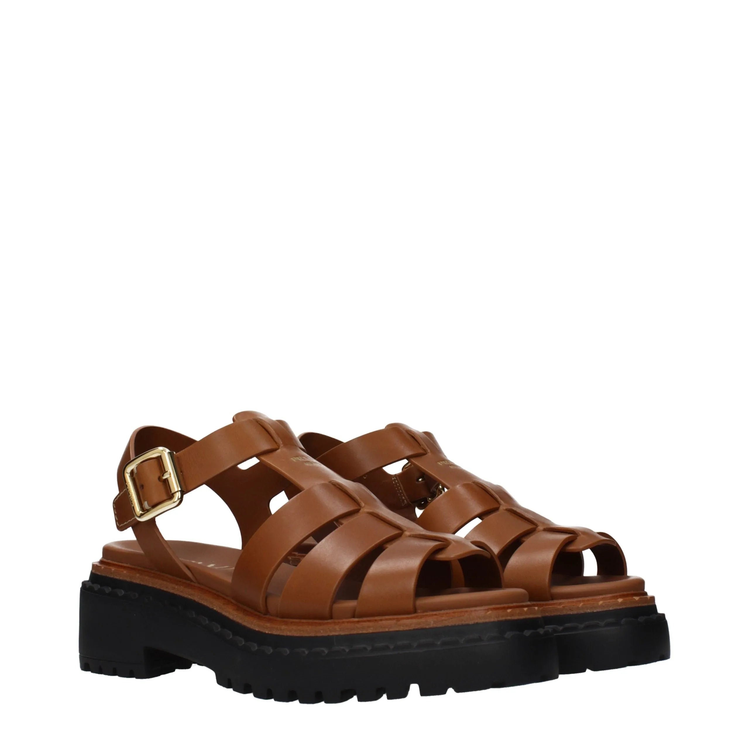 Brown leather Prada platform sandals with caged upper, ankle strap, gold buckle, and chunky black lug sole.