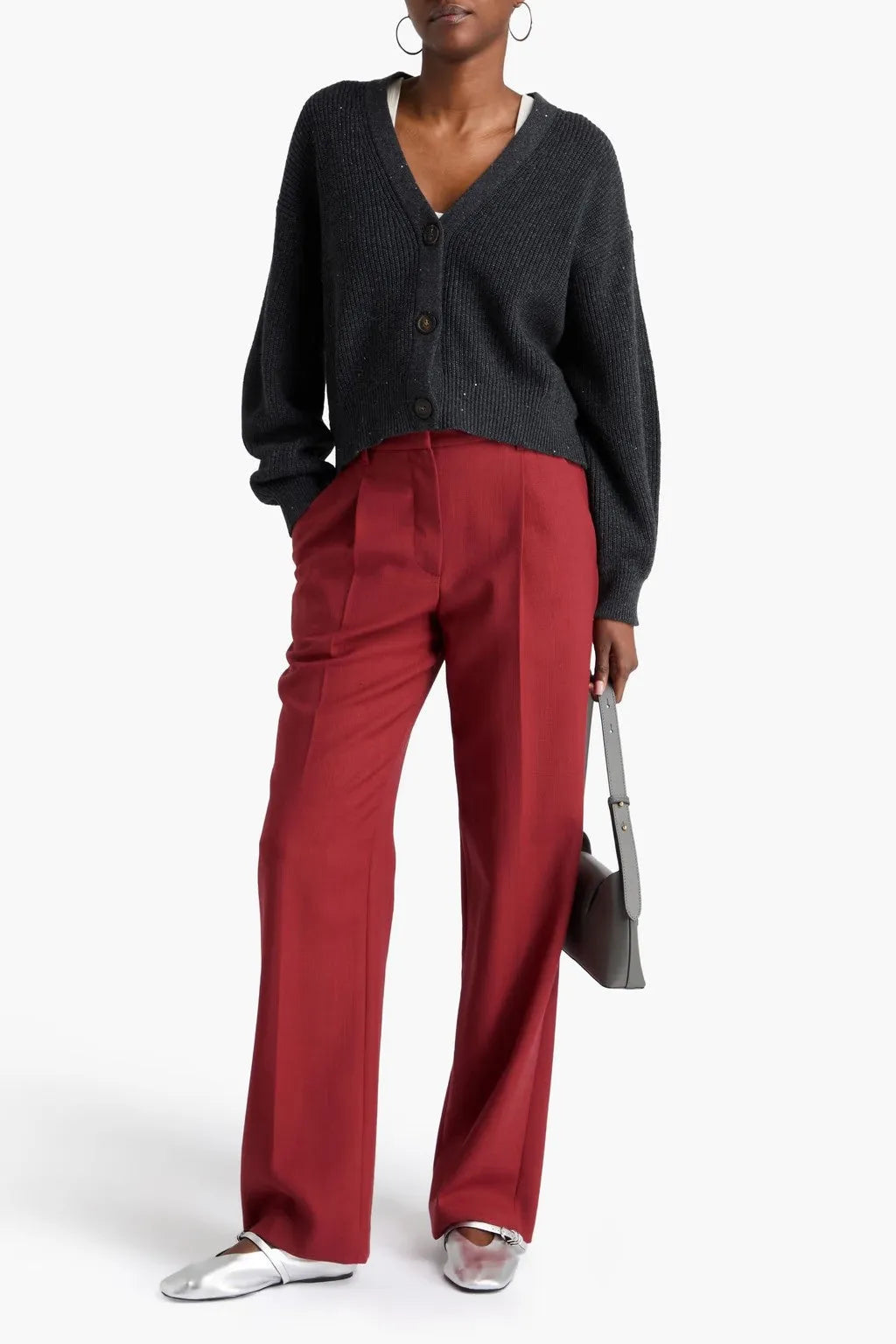 Brunello Cucinelli women's red wool tailored wide-leg pants with pleats, paired with a dark cardigan and silver shoes.