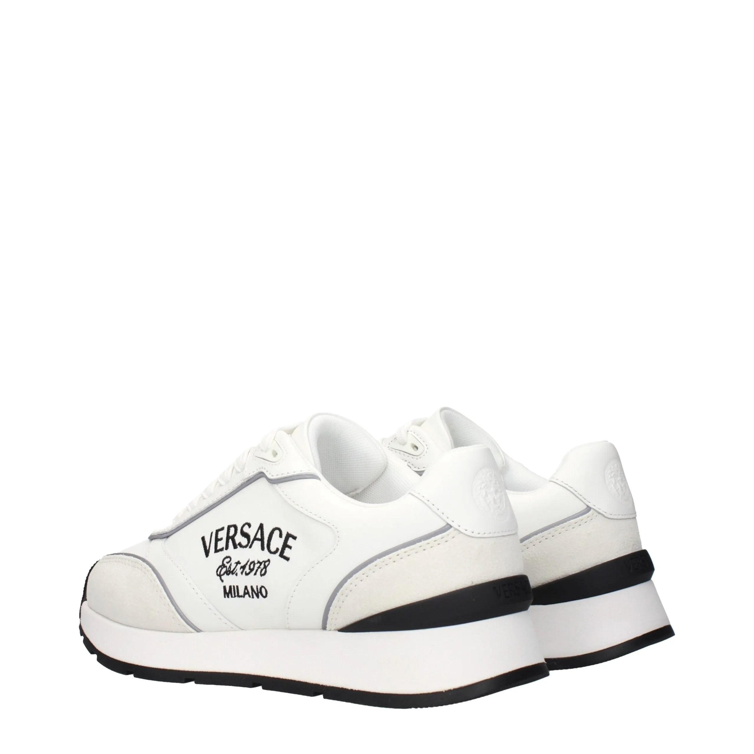 White leather Versace low top sneakers with suede accents, "Est. 1978 MILANO" side logo, and black sole details.