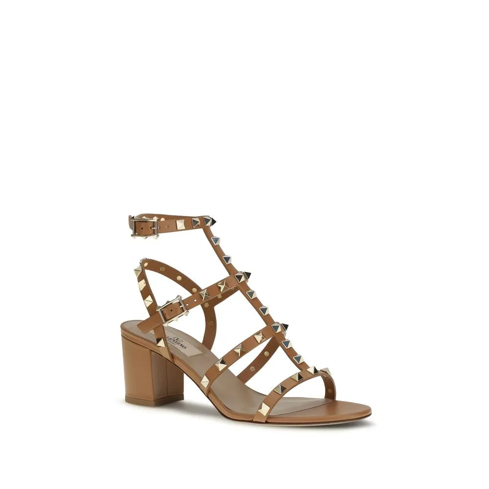 Beige calf leather strappy sandals with gold Rockstuds, adjustable ankle buckle, and a comfortable block heel.