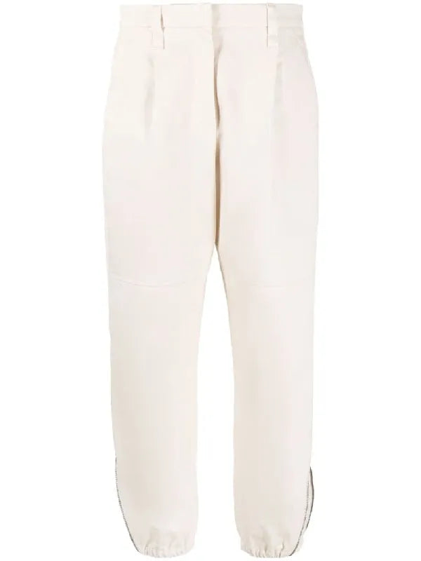 BRUNELLO CUCINELLI women's soy cotton casual pants with front pleats and zippered ankle cuffs.