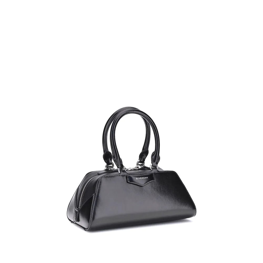 Structured black Givenchy Antigona East-West Mini handbag. Shiny calf leather, top handles, silver hardware, and front logo.
