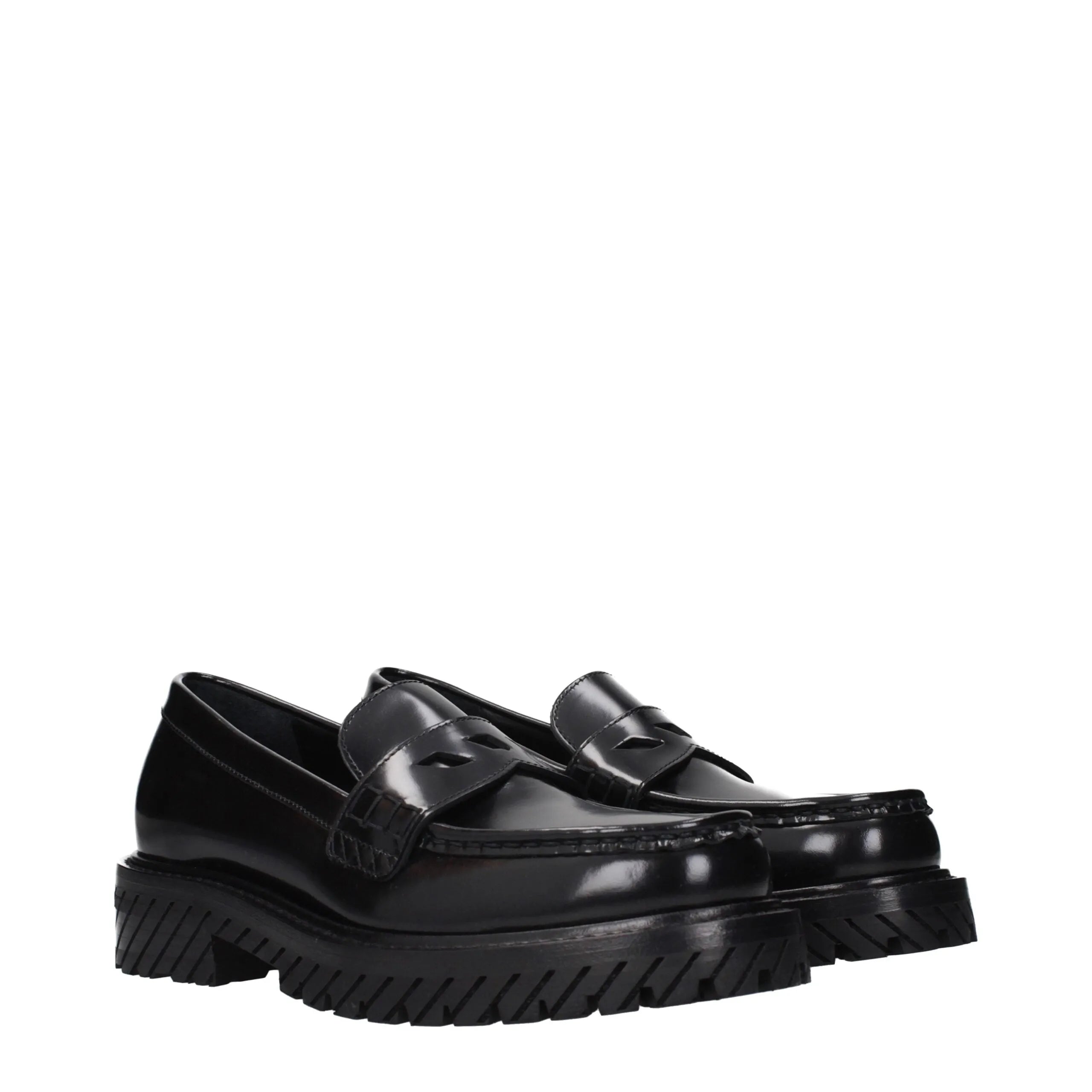 Black leather slip-on loafers with a glossy finish and chunky lug soles.