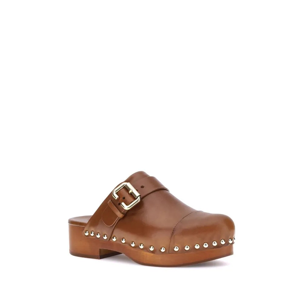 Brown calf leather clog with round toe, golden Paddington buckle, wooden platform, and metal studs.