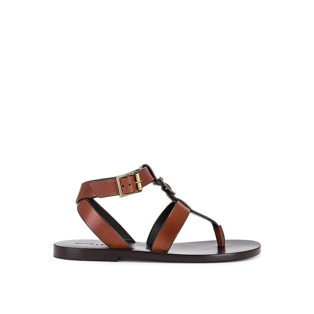 Women's brown calf leather flip-flop sandals with ankle buckle closure and brass-tone vamp detail.
